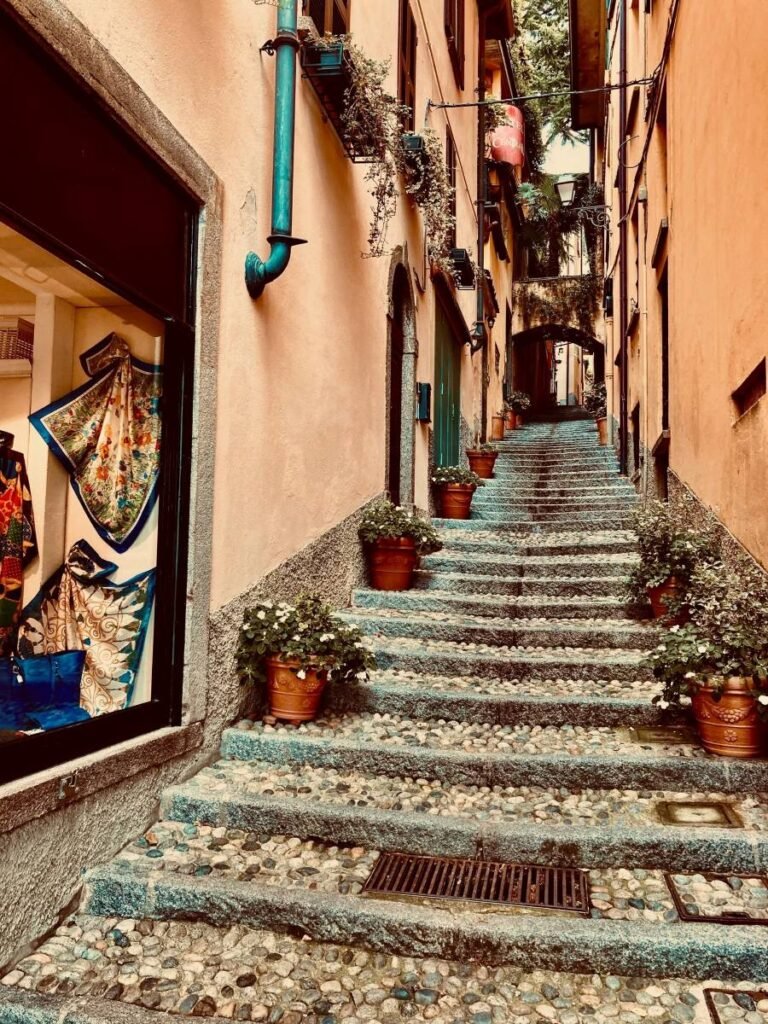 a charming, narrow, cobblestone street in the historic center of Bellagio